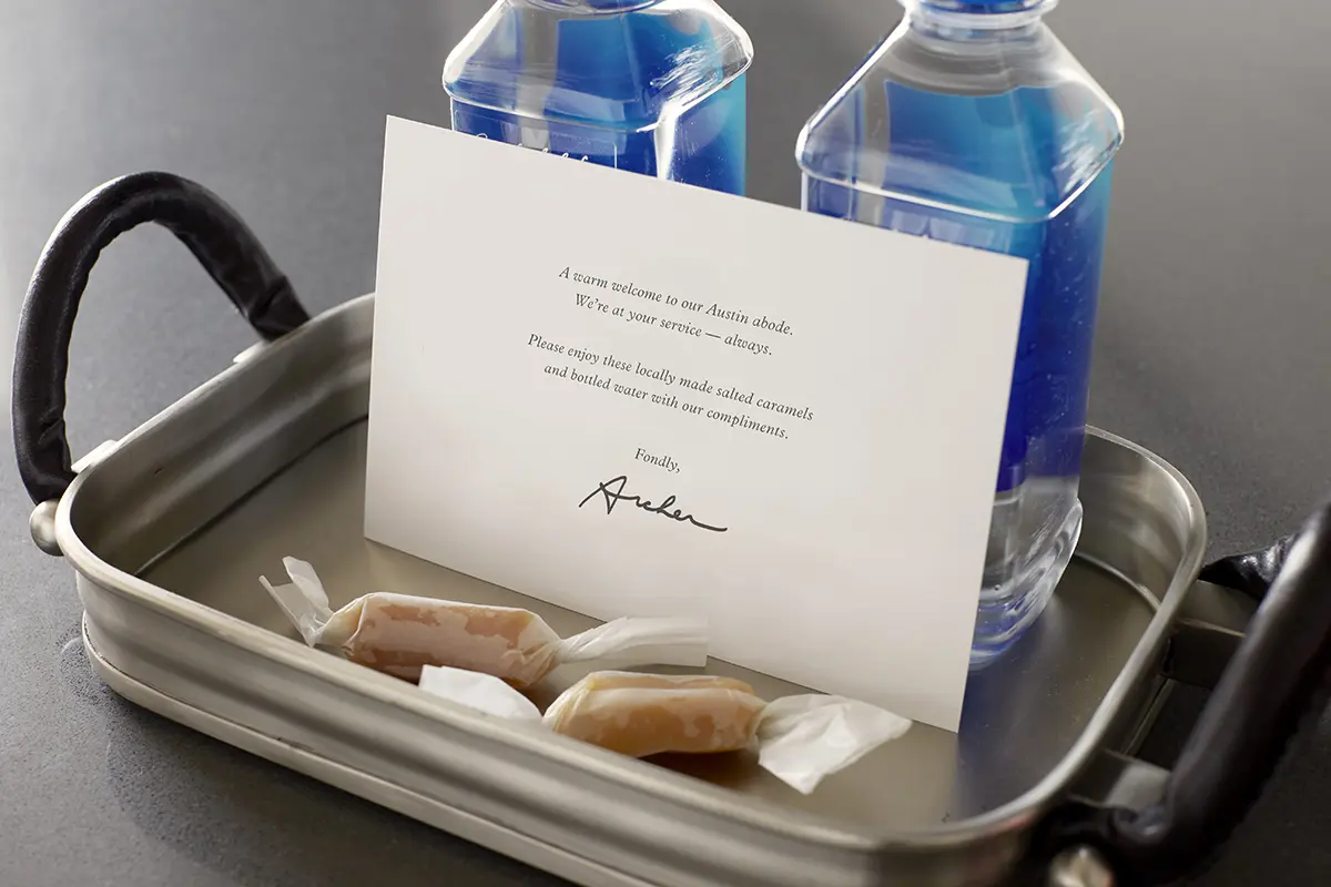 Welcome amenity of complimentary water, salted caramels and card