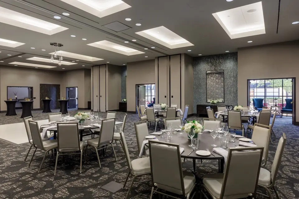 Great Room - mid-century inspired venue with banquet seating, cocktail tables and a white dance floor