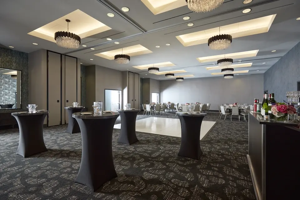 Great Room - mid-century inspired venue with banquet seating, cocktail tables and a white dance floor