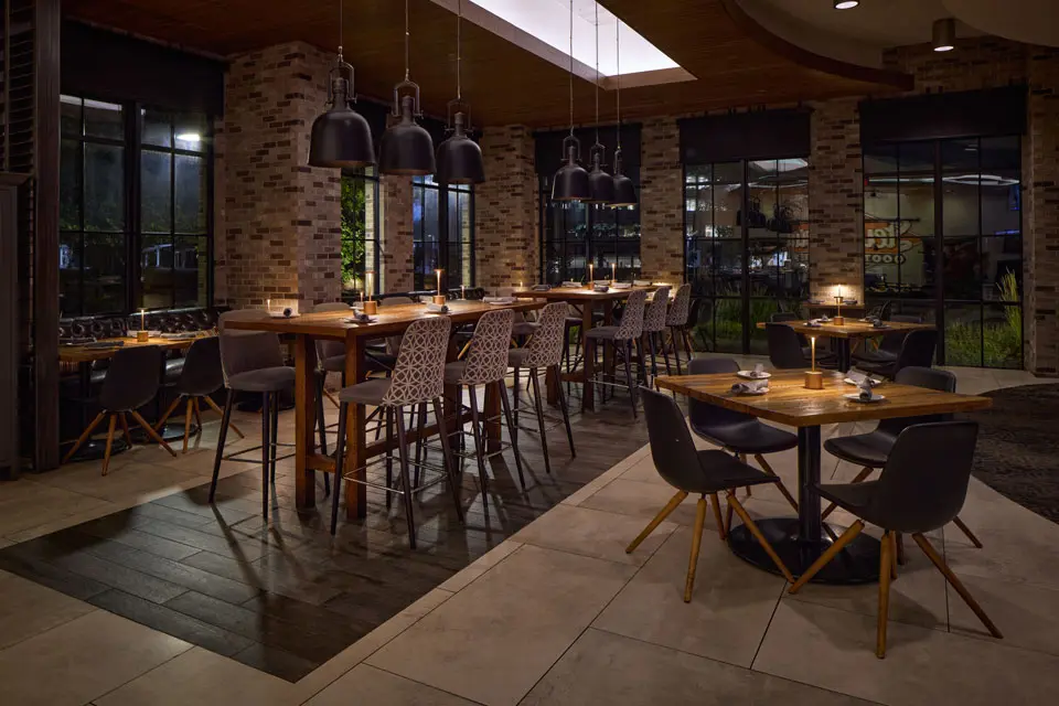 AKB - industrial-styled dining room with high-top and traditional seating