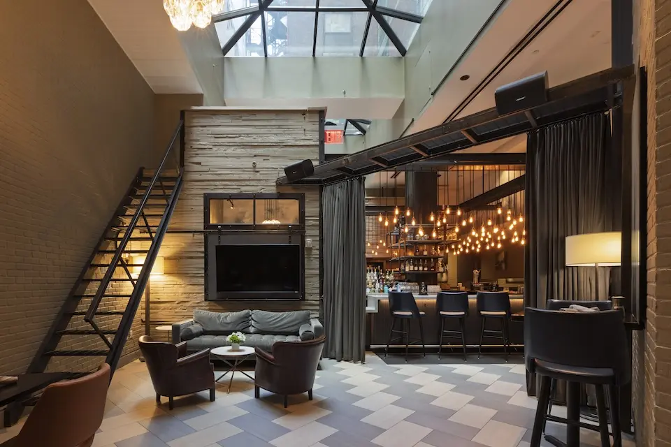 AKB - airy, brick-clad space with soft seating and a velvet curtain for optional privacy