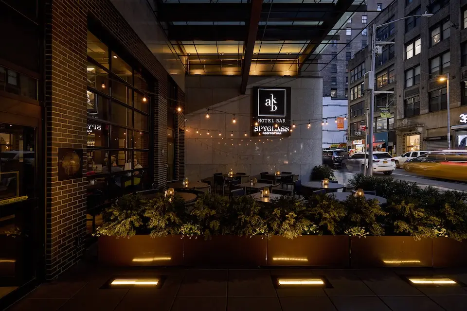 AKB - alfresco patio framed by planters featuring festoon lighting and 38th Street views