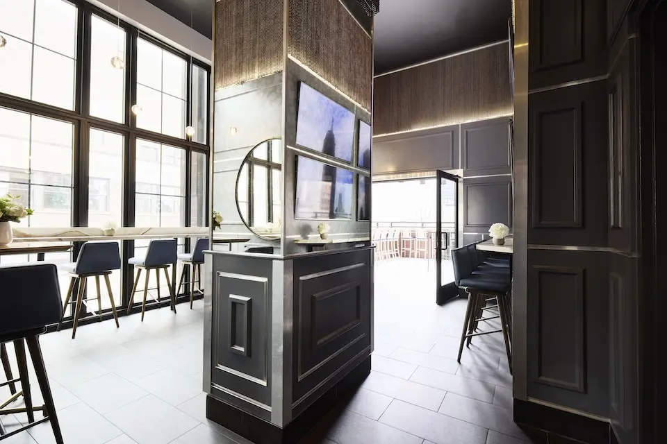 Spyglass - secluded back lounge featuring a four-panel display, floor-to-ceiling windows and private terrace access