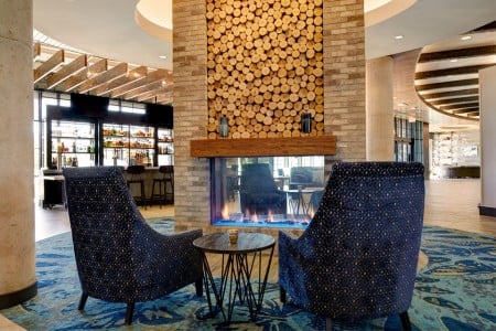 Hotel lobby fireplace with blue chairs