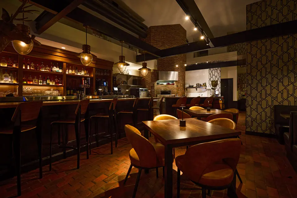 AKB Bar - with bar seating with a fully stocked liquor shelf