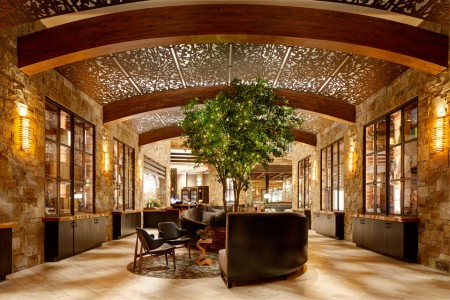 Archer Hotel Napa —Wine-country-inspired lobby with barrel-like ceiling, lit tree and centered seating
