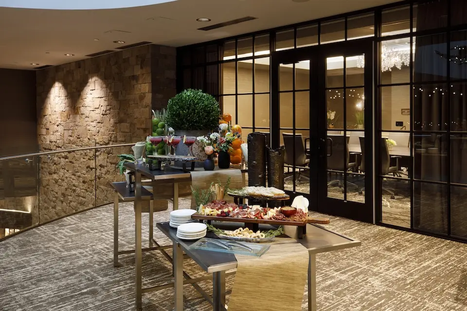 Balcony - elevated atrium venue with a central buffet table displaying cocktails and charcuterie