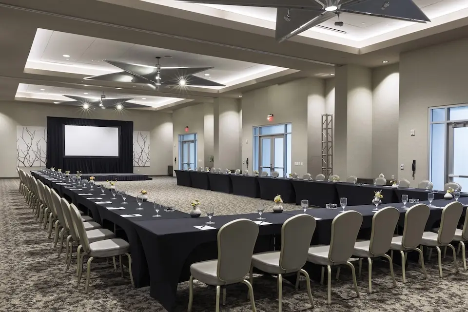 Grand Salon - corporate event with a U-shaped conference table and a projector screen