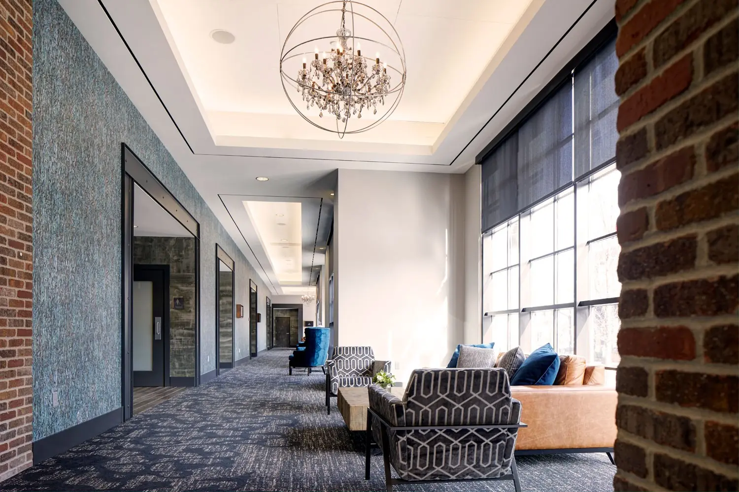 Great Room Foyer - prefunction space furnished with a mid-century leather couch and chairs