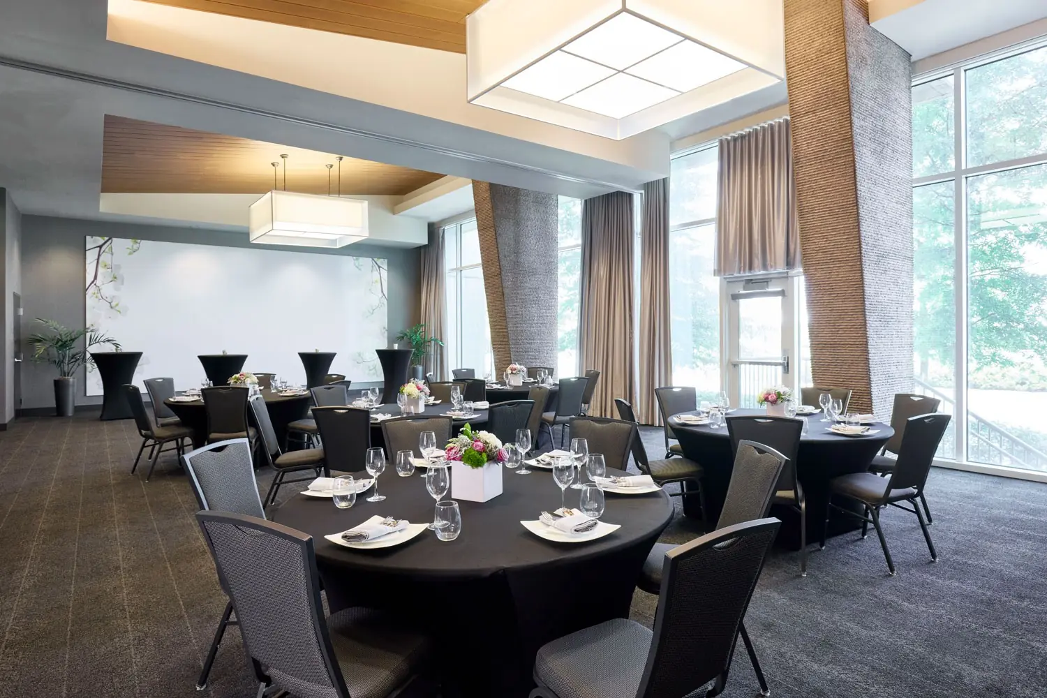 Great Room - social event with banquet seating, cocktail tables and floor-to-ceiling windows
