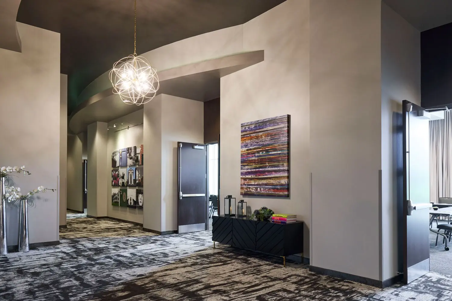 Great Room Foyer - open prefunction space featuring a geometric orb chandelier and hanging artwork