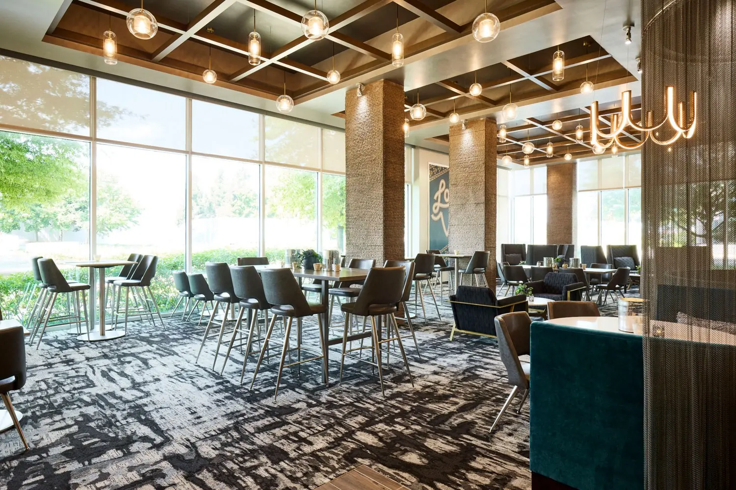 AKB - dining room with Corian-topped communal tables and floor-to-ceiling windows