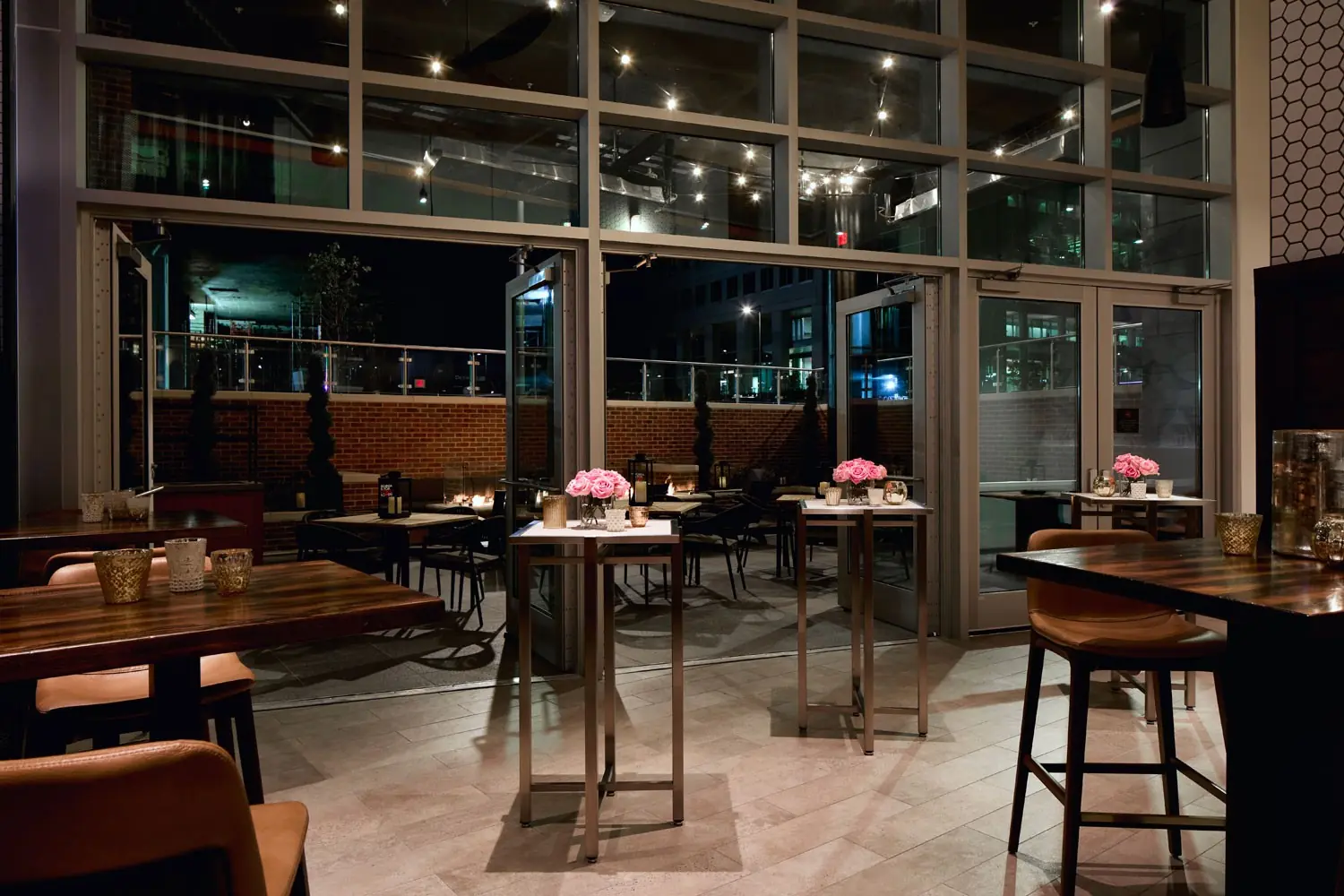 AKB - semiprivate back lounge set with table seating, cocktail tables and open doors leading to the patio