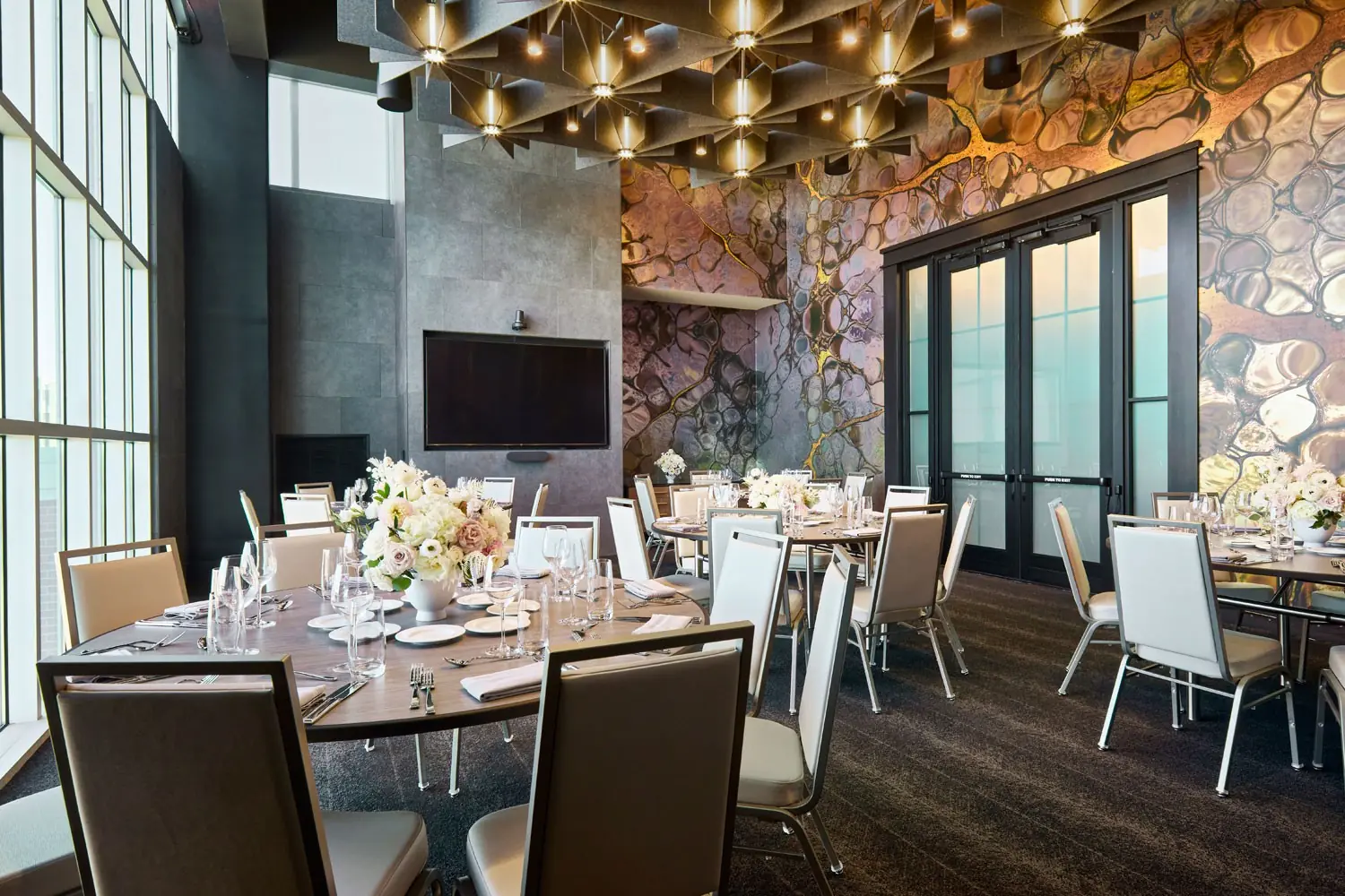 Moonlight Salon - banquet venue with floor-to-ceiling windows, dramatic metallic wallcovering and a wall-mounted TV