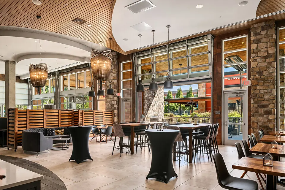 AKB - semi-private event with charcoal circular couch, cocktail tables and patio access