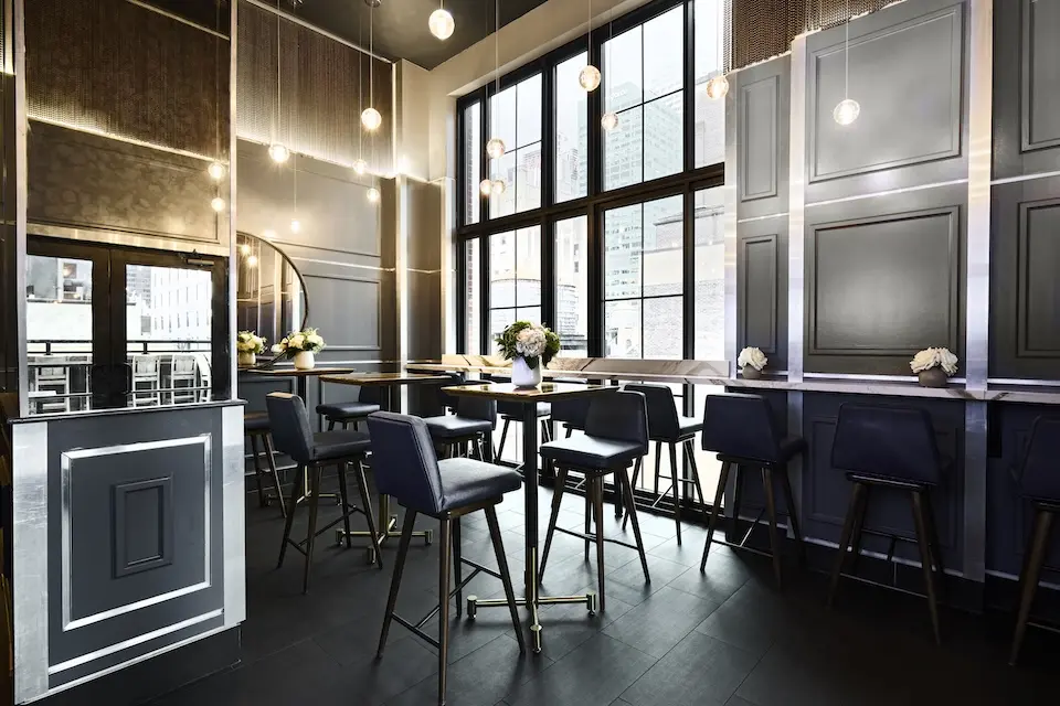 Spyglass - intimate lounge inspired by 1940s glamour featuring high-top tables, floor-to-ceiling windows and hanging pendant lights