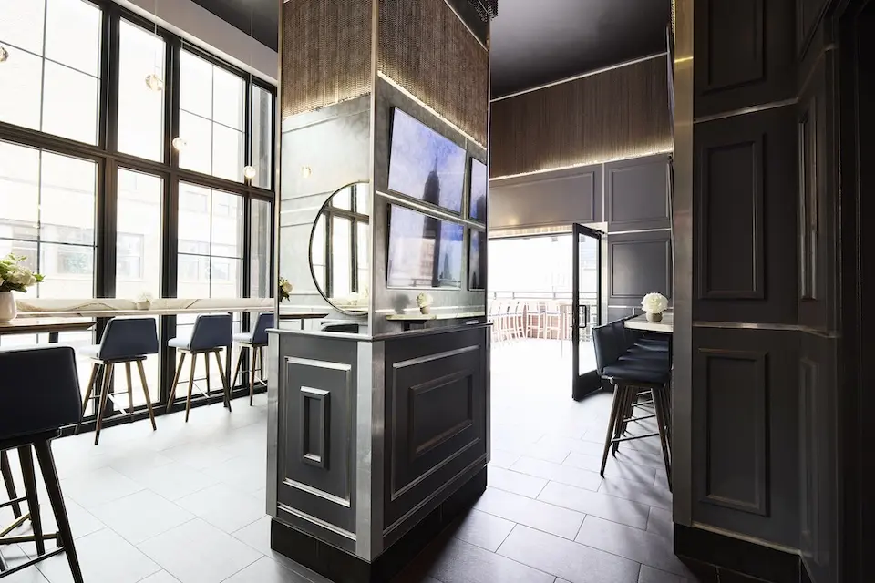 Spyglass - secluded back lounge featuring a four-panel display, floor-to-ceiling windows and private terrace access