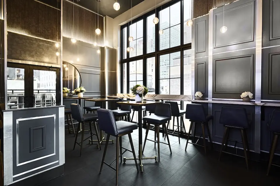 Spyglass - intimate lounge inspired by 1940s glamour featuring high-top tables, floor-to-ceiling windows and hanging pendant lights