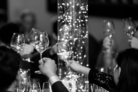 Black and White photo of glasses toasting