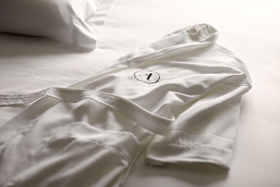 White Frette bathrobe on bed