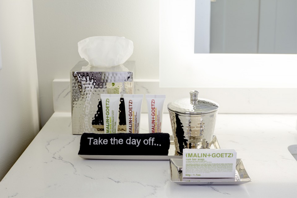 Malin+Goetz luxury bath amenities on bathroom vanity