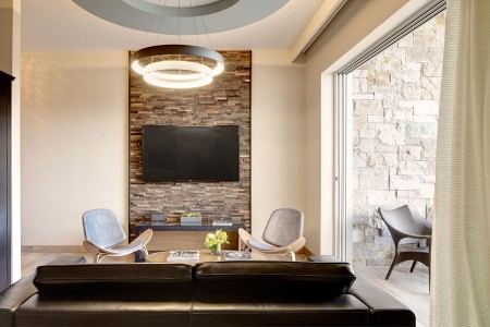 Archer's Den - living area with seating, 65-inch flat-screen TV and entrance to private balcony