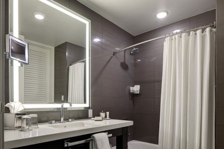Double Queen - bathroom vanity and mirror with a tub-shower combo