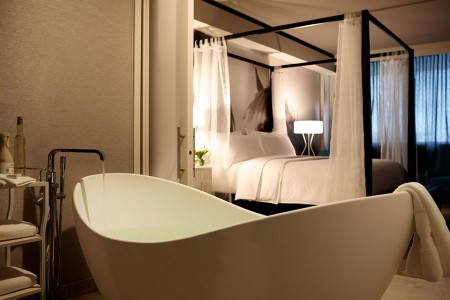Archer King Suite - modern soaking tub and four-poster bed