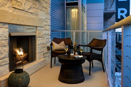Balcony experience with lounge seating and limestone fireplace