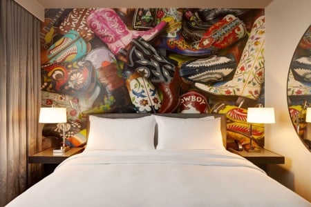 Classic King - bed with five-star bedding and local cowboy boot mural