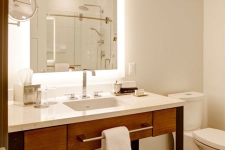 Modern bathroom with weathered iron vanity and mirror