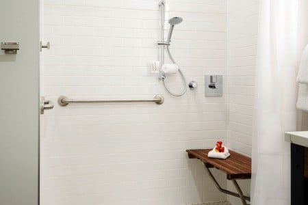 Classic King - mobility-accessible roll-in shower with shower seat, hand-held shower wand and grab bars