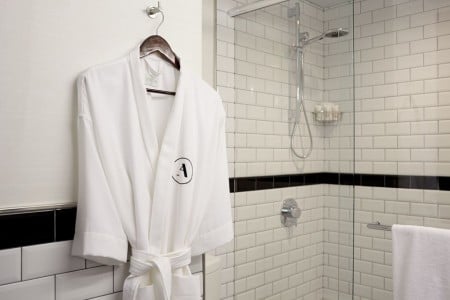 White Frette robe hanging near shower