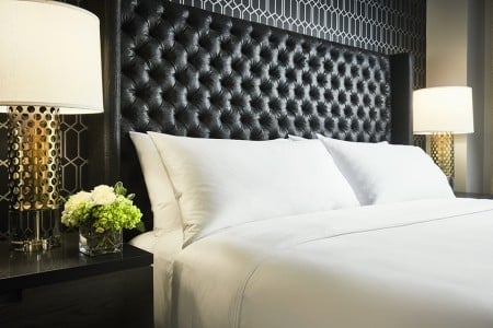 Archer King Suite - bedding detail with bedside lamps and large headboard