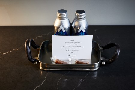 Welcome amenity of complimentary water, handmade salted caramels and card
