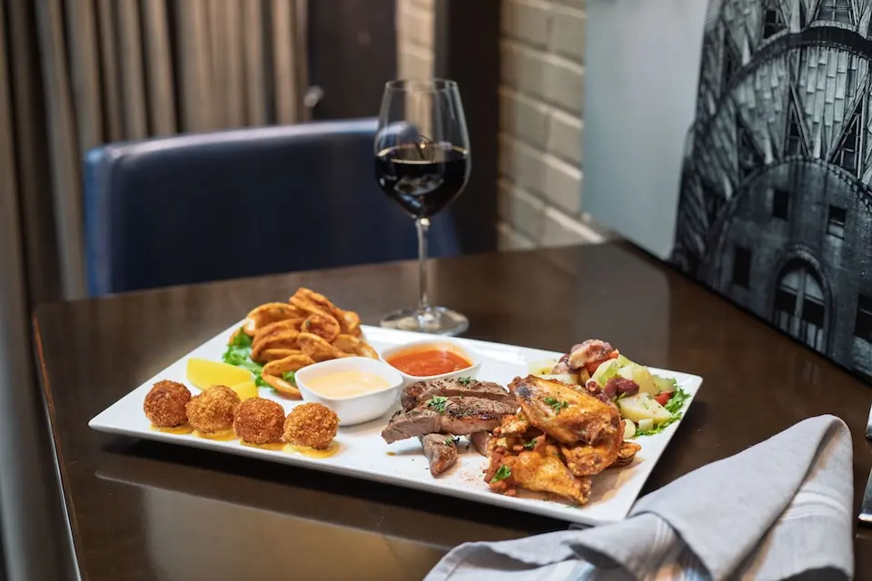 AKB - Surf & Turf Sampler appetizer platter paired with a glass of red wine