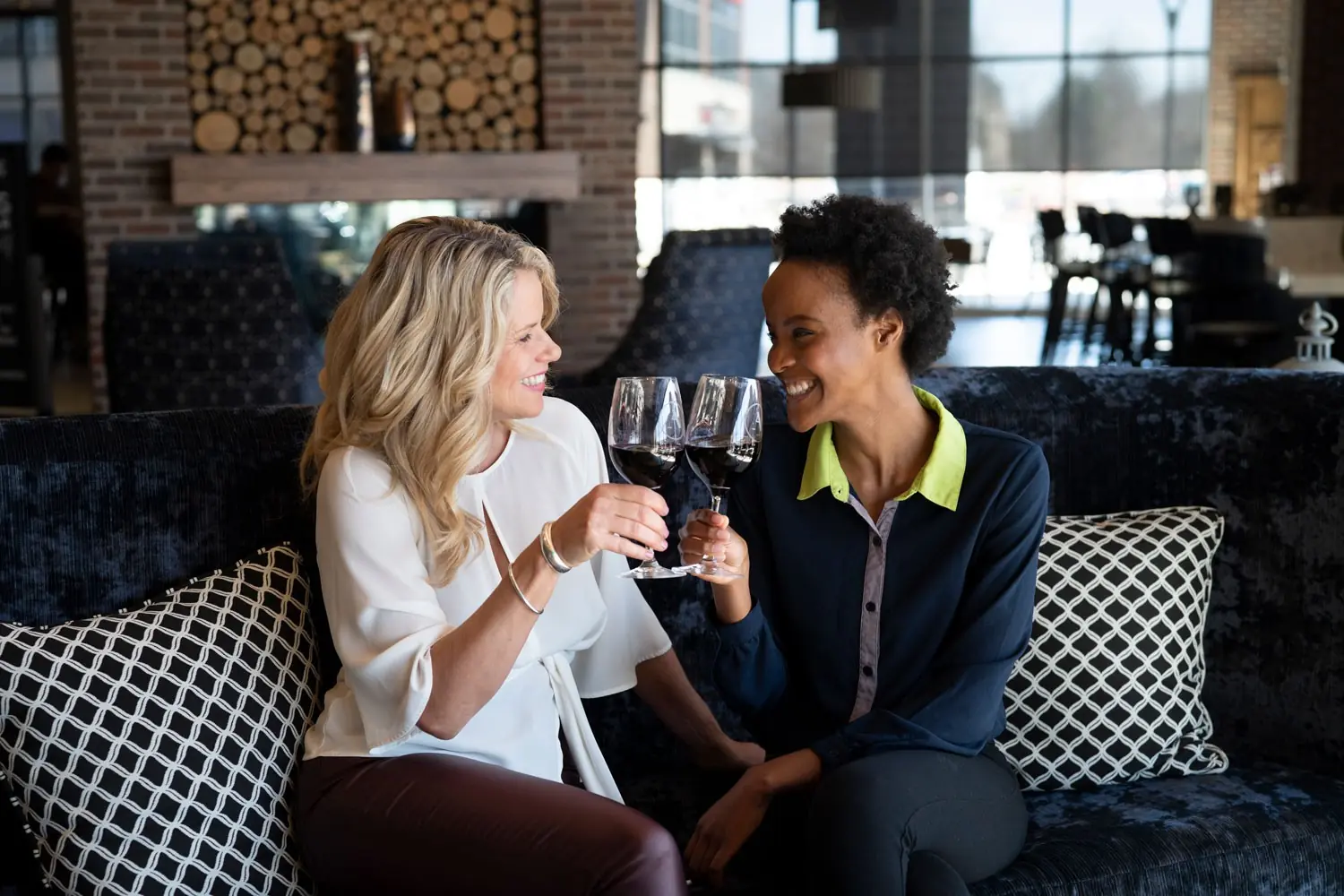 Girls drinking wine in the lobby of Archer Hotel