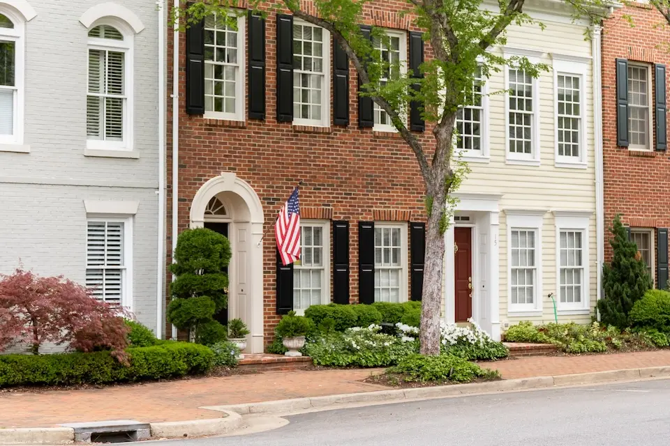 Alexandria Historical District - historic rowhouses with red brick sidewalks and an American flag
