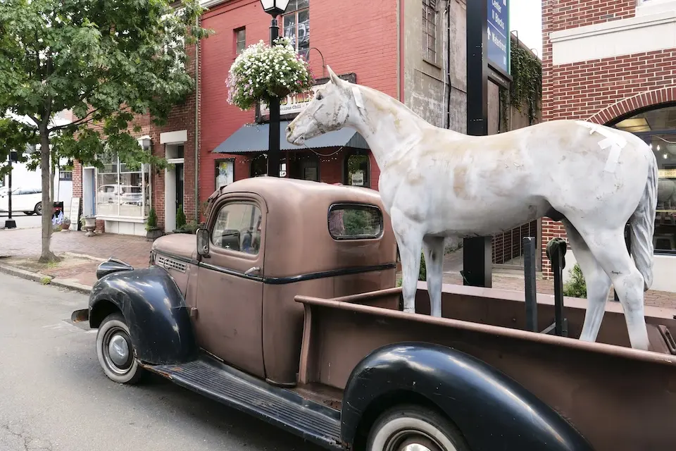 Old Town Alexandria - Hard Times Horse landmark featuring a white horse standing in the back of an antique pickup truck
