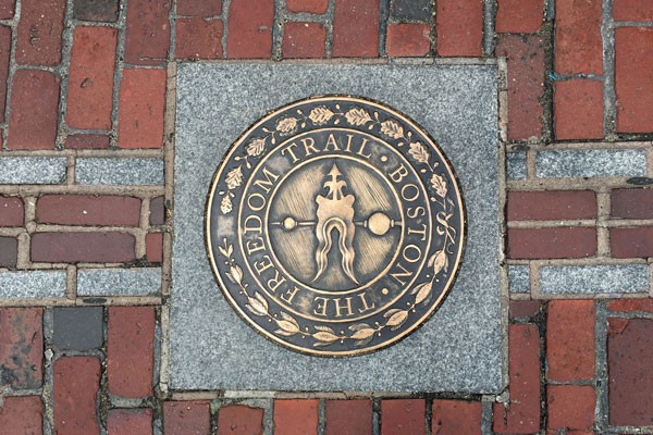 The Freedom Trail Boston metal sign inside the brick 