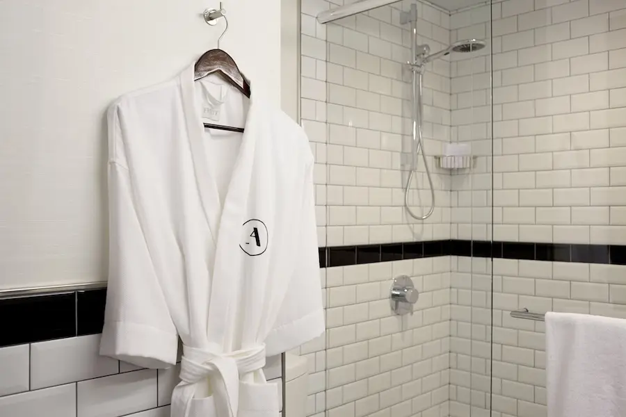 Archer King - white Frette robe hanging near shower