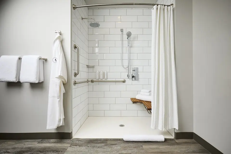 Classic King - mobility-accessible roll-in shower with shower seat, hand-held shower wand and grab bars