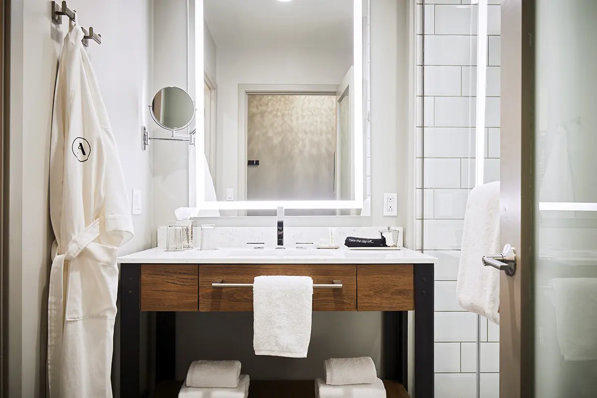 Modern bathroom featuring a weathered iron vanity and white subway-tile walk-in shower