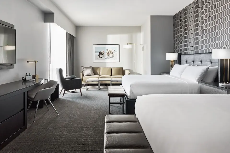 Double King - two plush king beds with an accent wall, bedside lighting and oversized desk