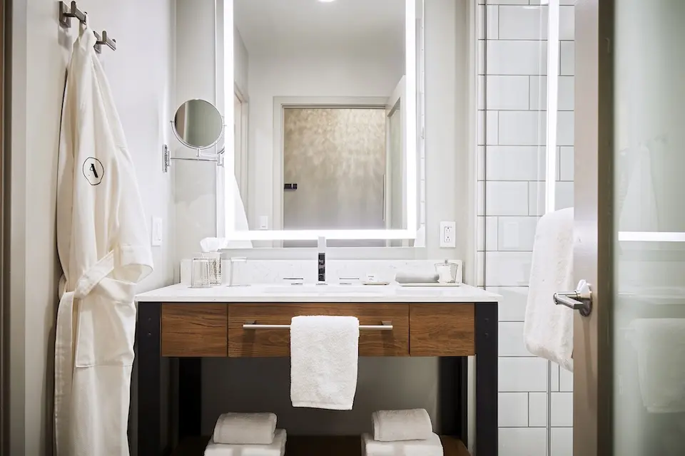 Double King - modern bathroom with weathered iron vanity, mirror and luxury bath amenities