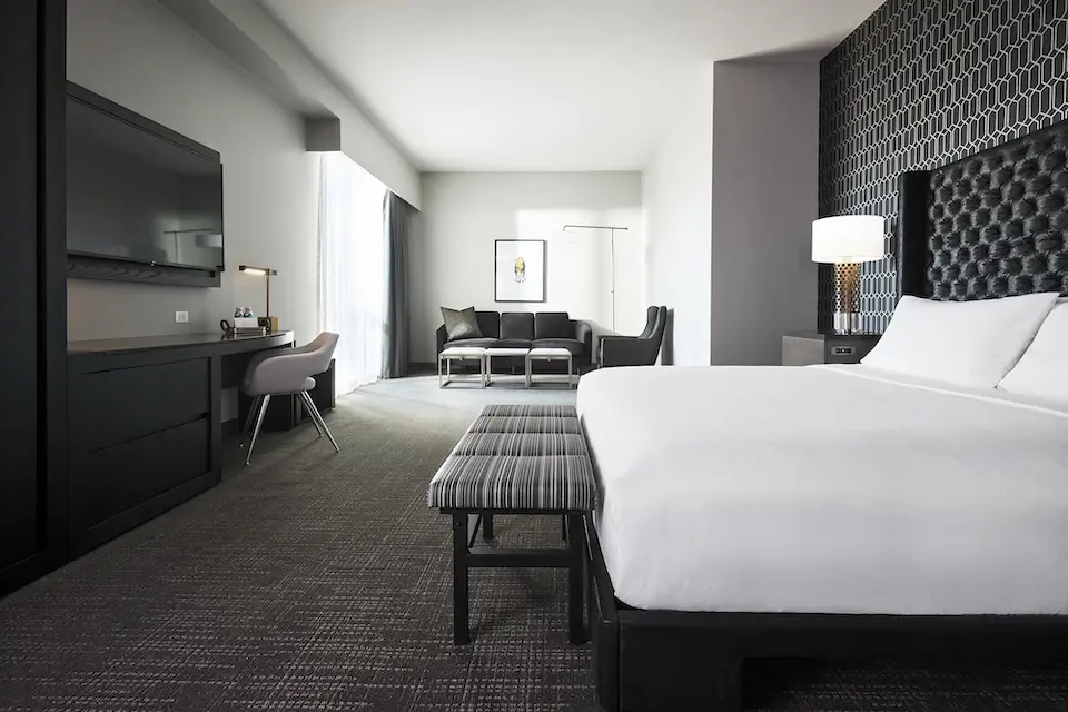 Archer King Suite - platform bed, oversized desk and spacious living area with sofa