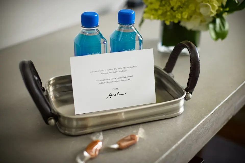 Welcome amenity of complimentary water, handmade salted caramels and card