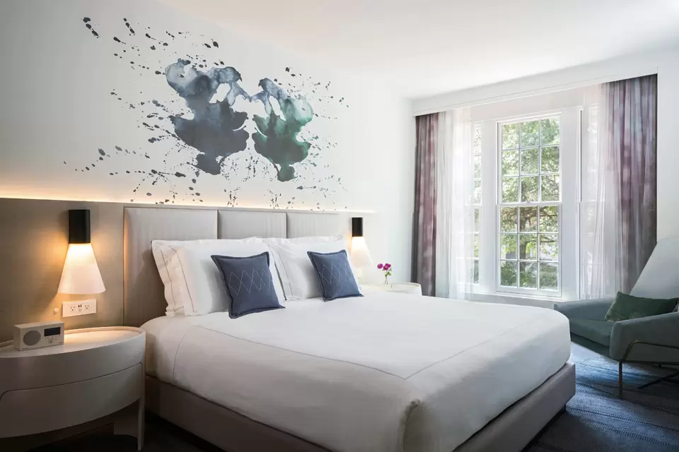 Guestroom with wall art and light fixtures