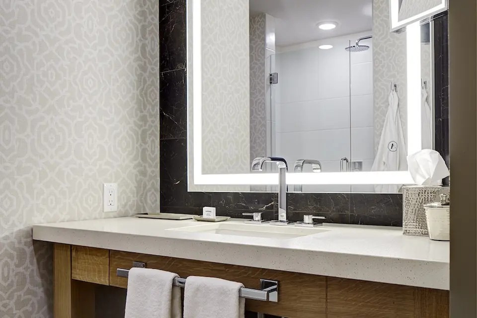 Deluxe King - elegant bathroom vanity with backlit mirror and luxury bath amenities