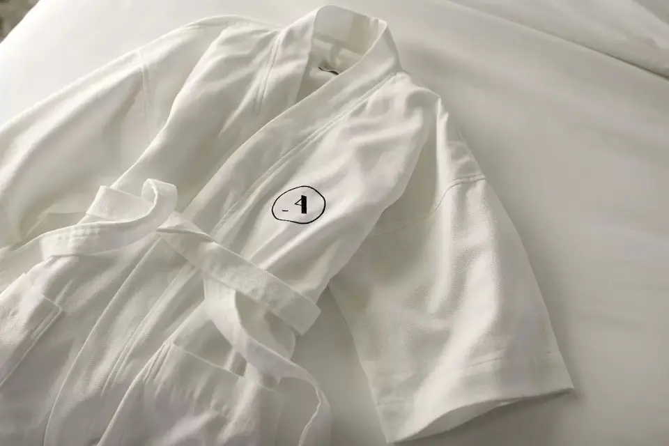 Frette bathrobe on white bedding